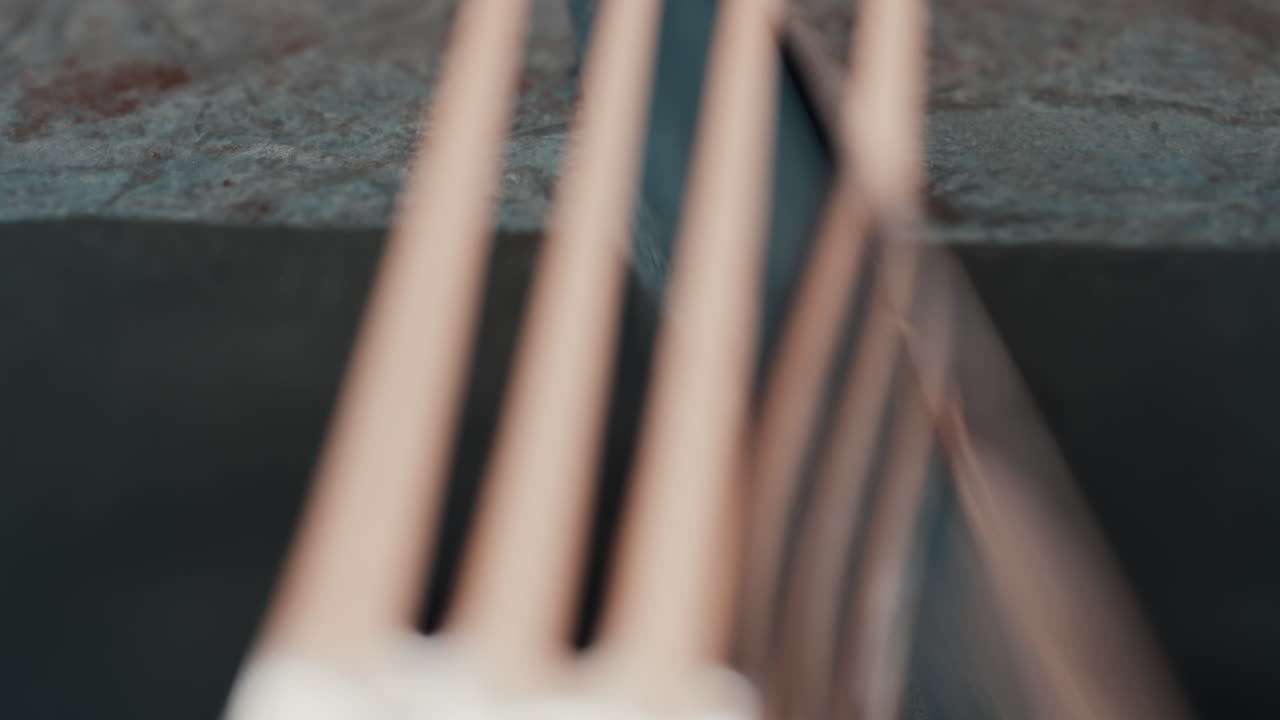 Close up of silver cutlery placed neatly on a dark napkin at a restaurant