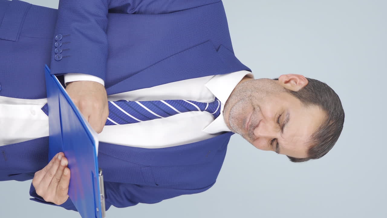 Vertical video of Yawning businessman.