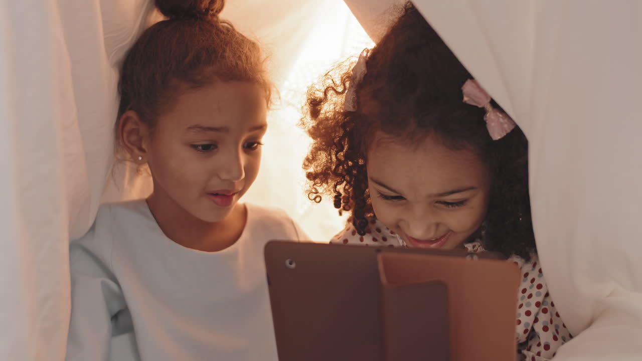 Girls Using Tablet Computer in Pillowfort