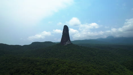 aerial view approaching the pico cao grande volcanic plug peak in sao tome