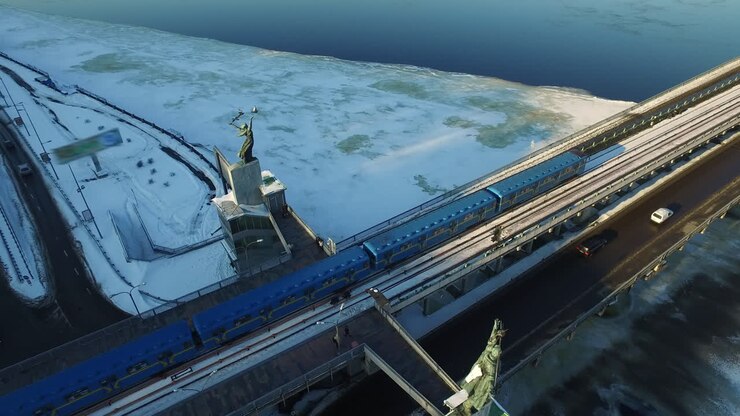 Drone view of subway train driving on outdoor railways
