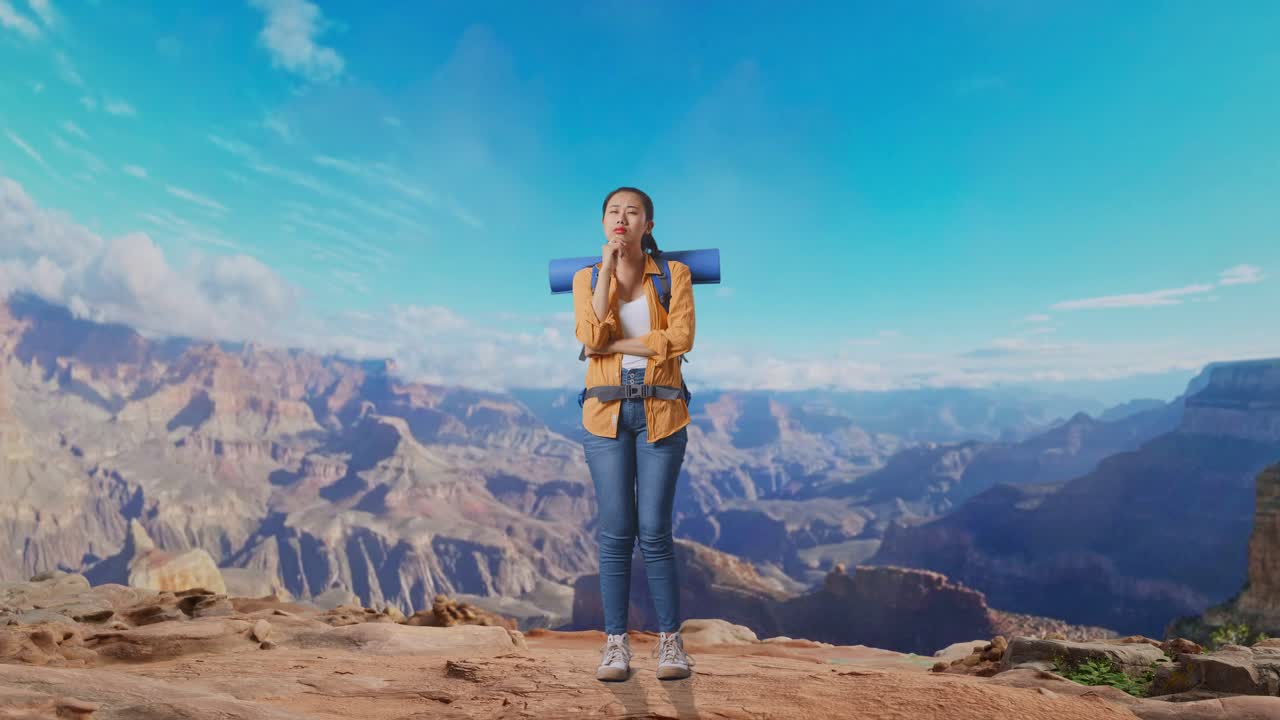 Full Body Of Asian Female Hiker With Mountaineering Backpack Thinking About Something And Looking Around Then Raising Her Index Finger While Traveling At The Top Of Mountain