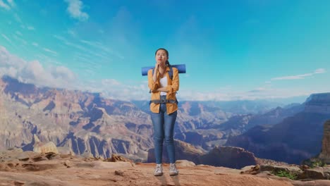 full body of asian female hiker with mountaineering backpack thinking about something and looking around then raising her index finger while traveling at the top of mountain