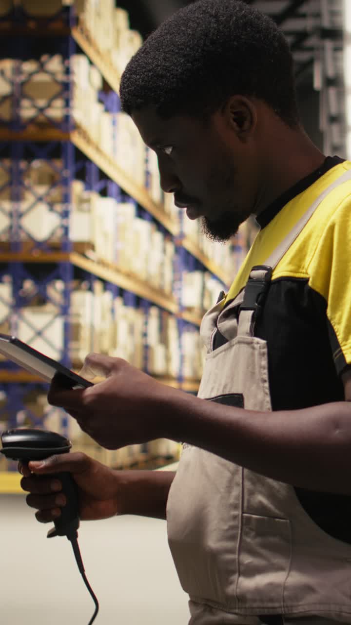 Vertical Video Black staff member using a barcode scanner to process shipping labels