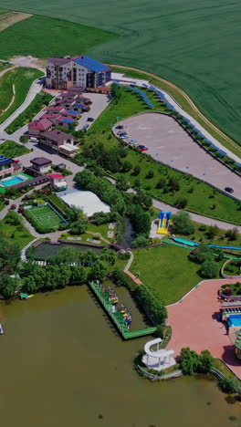modern recreation complex. beautiful green territory of popular recreational center for outdoor weekend in summer. aerial view. vertical video