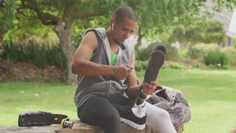 front view man readjusting his prosthetic leg