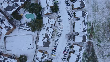 a-view-from-above-of-the-snow-storm-that-left-everything-painted-white,-houses,-buildings,-streets-and-cars