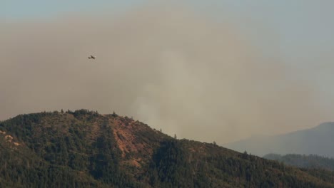 firefighting plane fly high over massive forest wildfire to see the damage