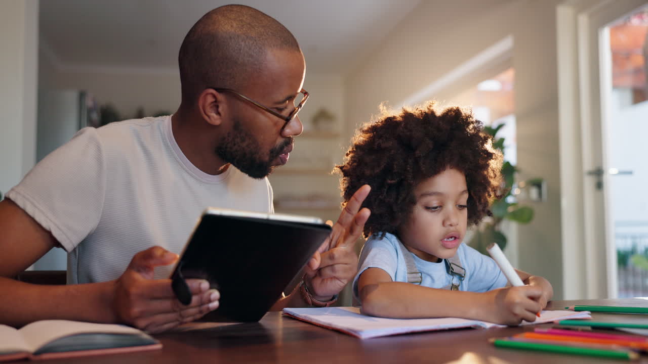 Father helping son with homework using a tablet