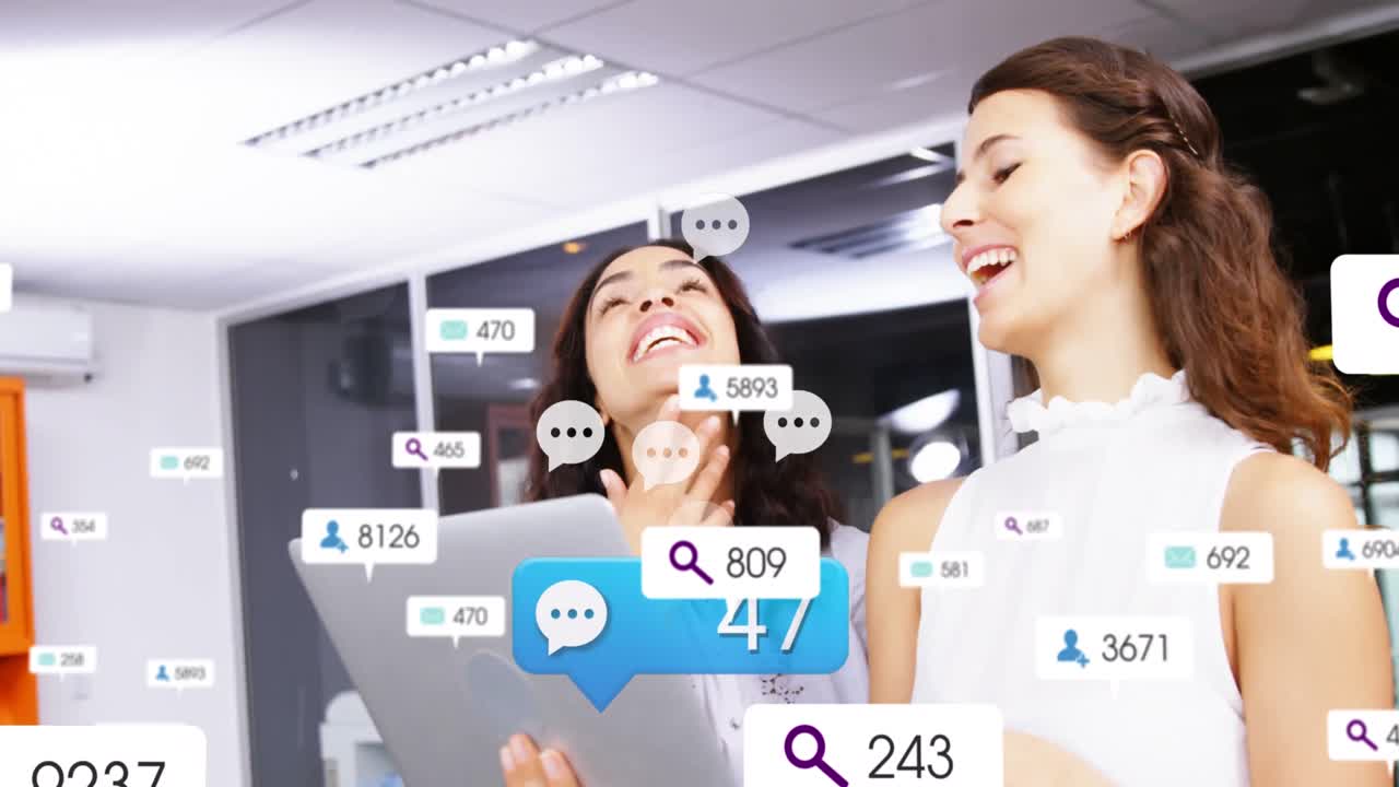 Animation of notification icons with numbers over diverse women laughing while discussing on laptop