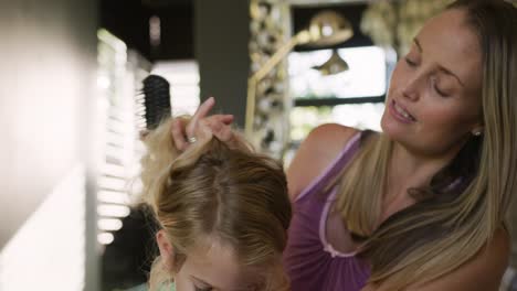 Mother-brushing-the-hair-on-her-daughter