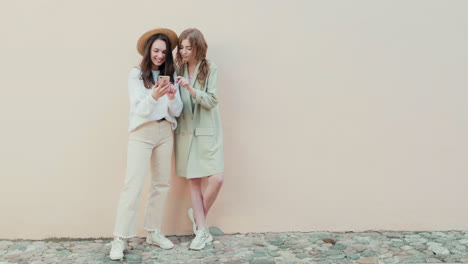 two young women looking at a smartphone