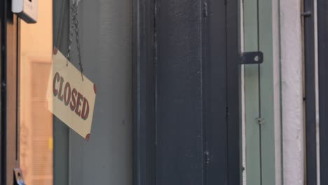 a closed sign hanging on a door