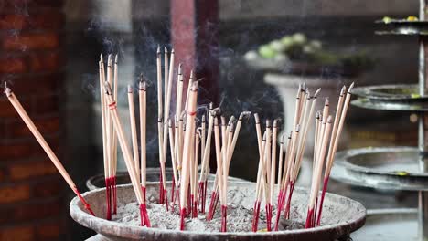 incense sticks burning in a pot