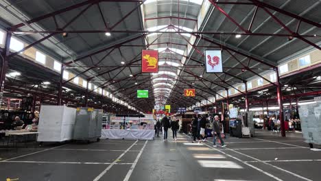 shoppers and vendors at bustling market stalls