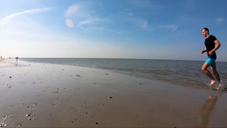 Cinematic-scenery,-man-running-on-the-beach-in-slow-motion