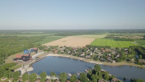 drone view approaching the lake and water park in the resort hof van saksen - nooitgedatch, in the netherlands