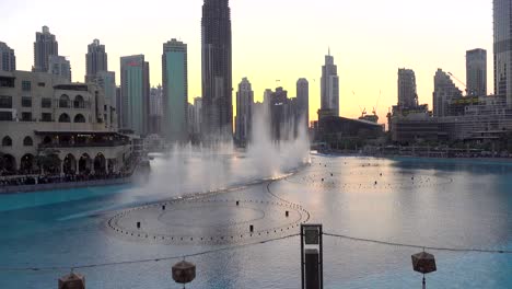 video, famous singing fountain from dubai, in front of burj khalifa at sunset, dubai, uae, february 10, 2019