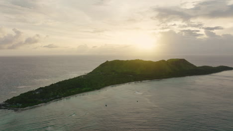 long green island glowing in golden light with calm turquoise water