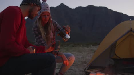 caucasian couple camping in nature by night