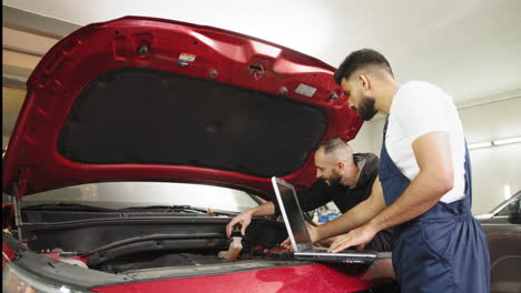 car repair by two mechanics in a garage