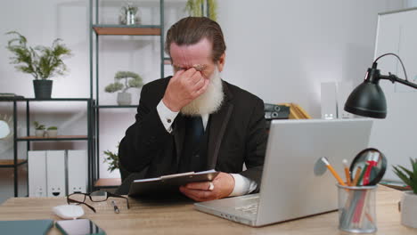 stressed senior man feeling worried about problem analyzing information, bankruptcy, money debt