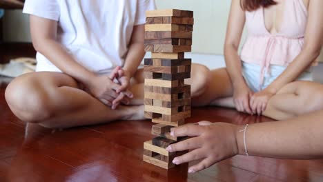 dos personas jugando a jenga hasta que la torre se derrumba