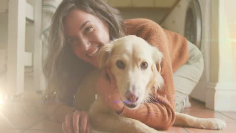 punto de luz contra la mujer caucásica jugando con su perro en casa