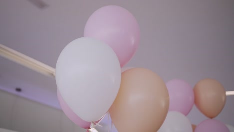 airy pastel balloons floating gently in a celebration setting