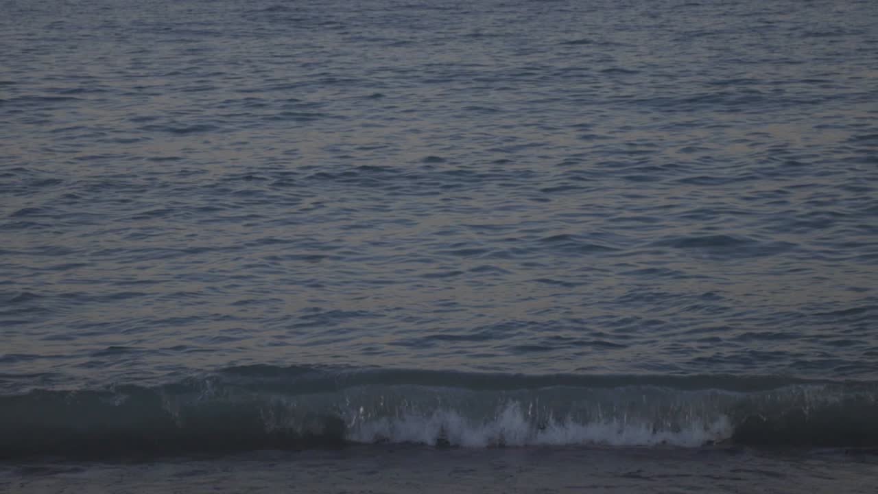 Blue Sea Wave On The Sandy Shore During The Golden Hour.- medium shot
