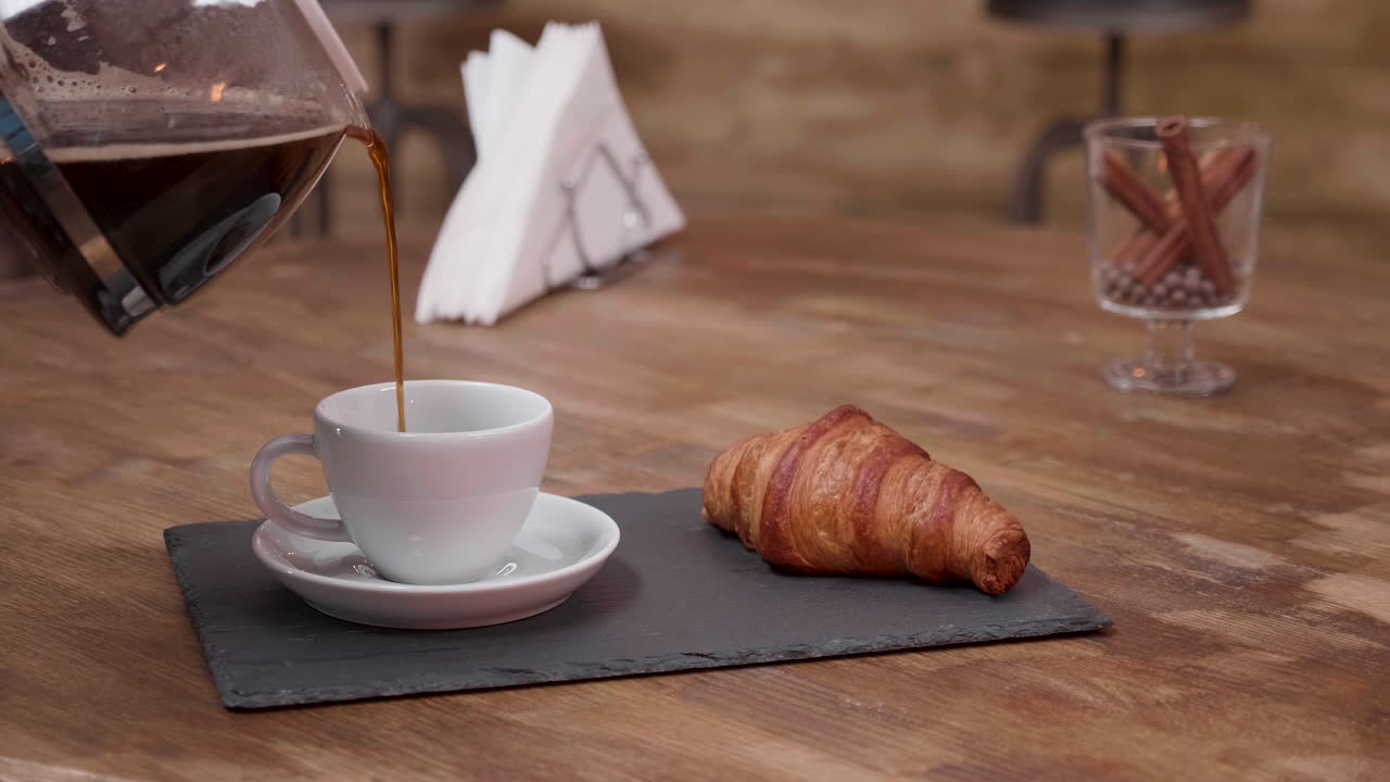 Coffee and croissant in a cafe