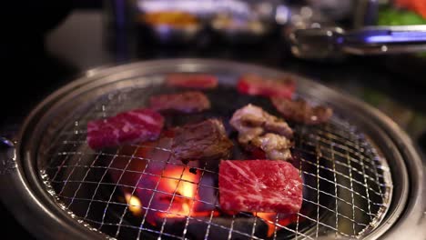 beef and bacon grilling on a restaurant grill