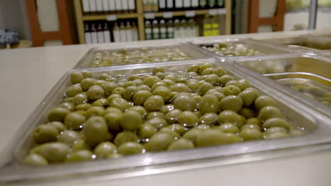 green olives in a deli display