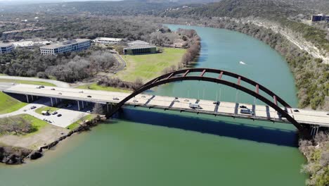 aerial austin pennybacker bridge - with full bridge expanse in frame including boat landing, moving towards the bridge until the length nearly fills the edges of the frame.