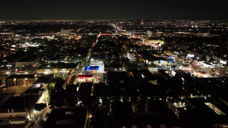 vista aérea volando a través de hollywood los angeles paisaje urbano nocturno horizonte iluminado