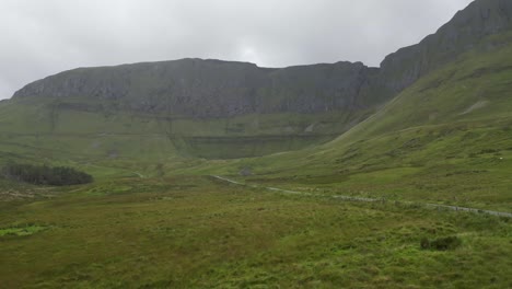 Drone-shot-flying-in-the-rain-towards-Glenniff-Horseshoe-and-ruins-of-an-old-building