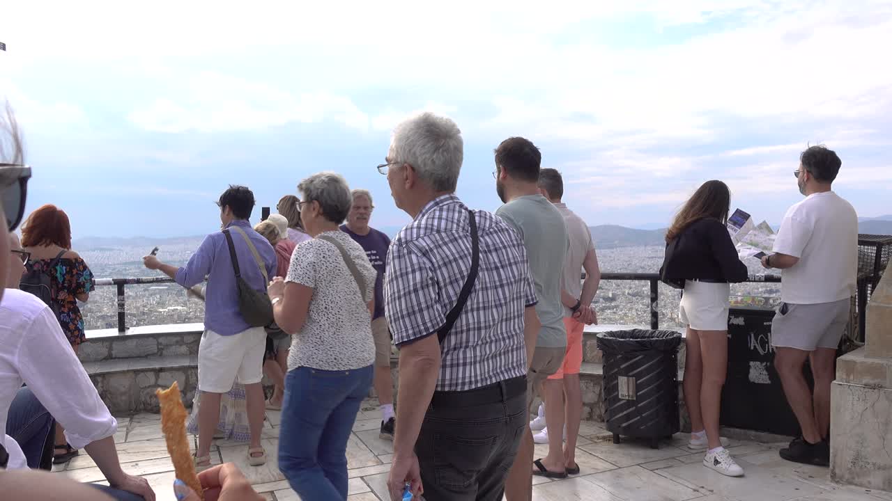 Crowd of tourists enjoying views over Athens from Lycabettus Hill