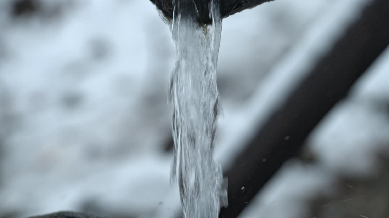 A peaceful fountain stands amidst a snow-covered landscape in Shirakawa-go, Japan.