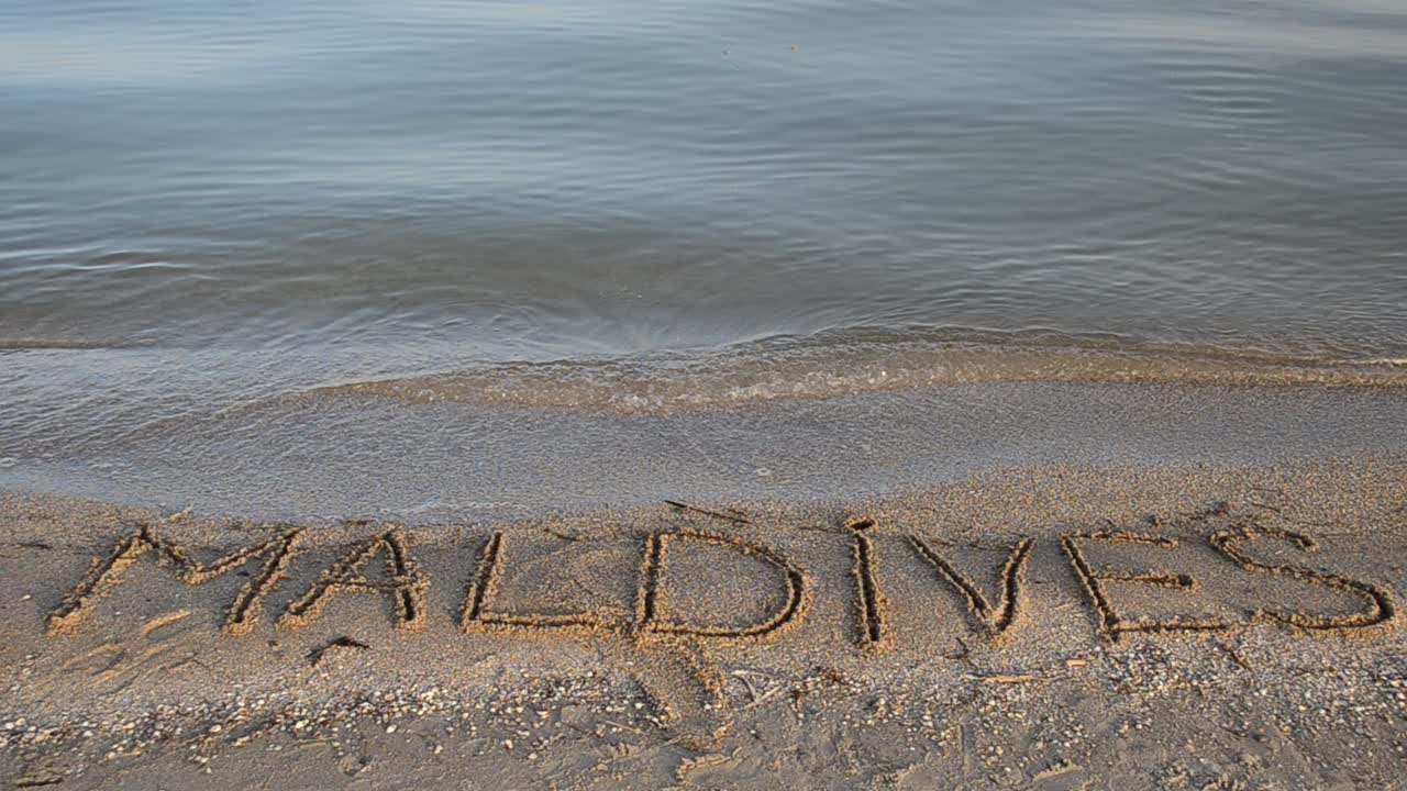 Maldives the inscription on the sand. Inscription on sand, the beach