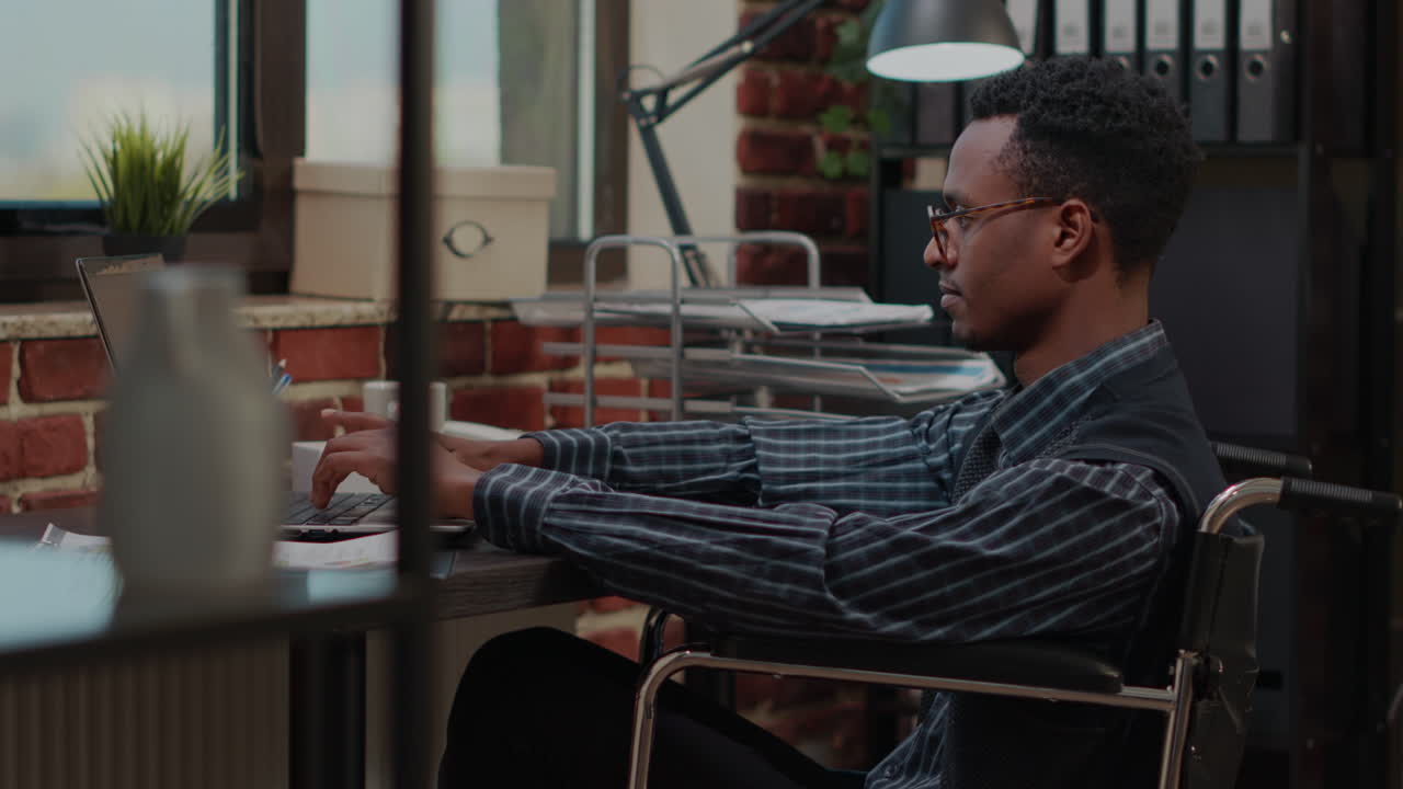 Employee with special needs working on laptop to plan strategy