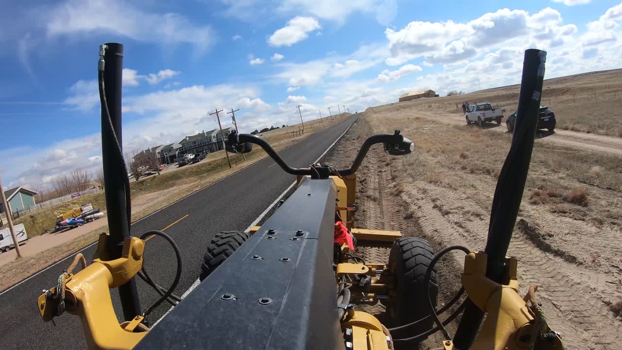 Road Grater POV shot.  Grading ditch on country road