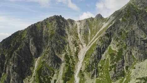 breathtaking scenery of green rocky mountain near skok waterfall high tatras in slovakia - aerial shot