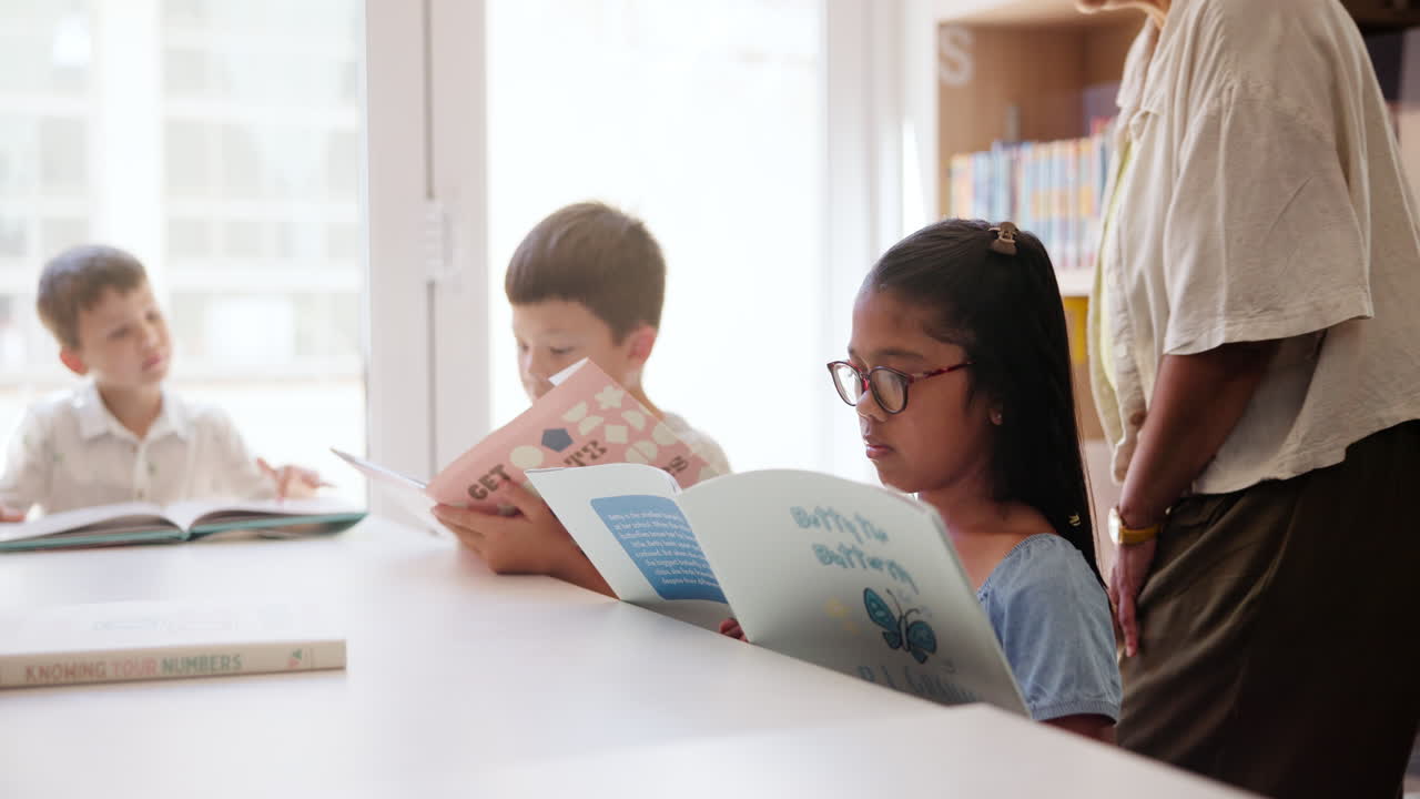 Children Reading Books with Teacher in Library