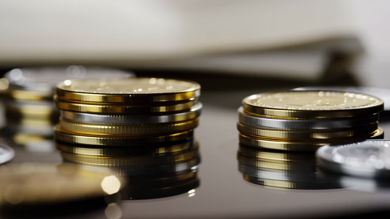 Closeup Stacked Coins On Reflective Surface, Macro View Of Gold And Silver Coin Piles With Soft Bokeh
