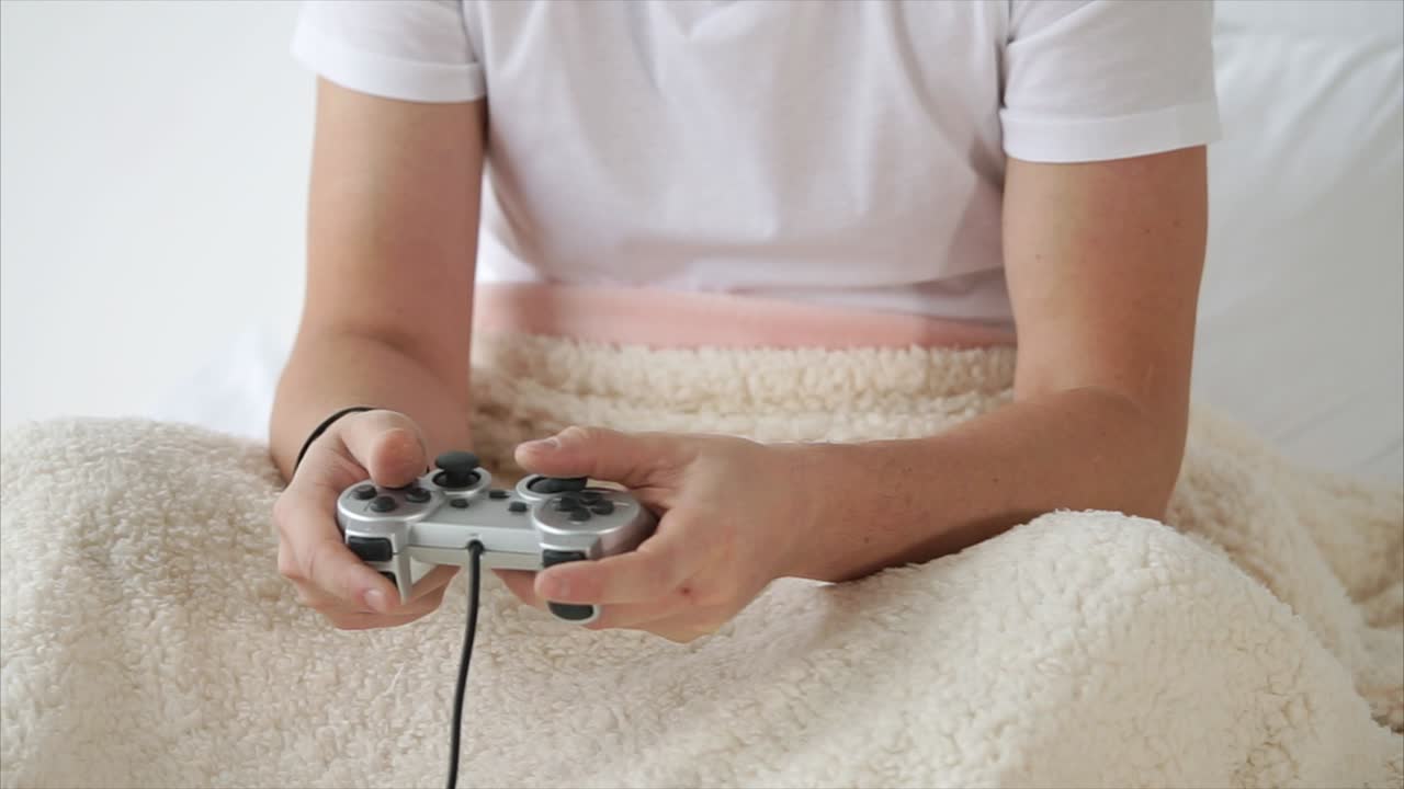 Person Playing Video Games in Bed