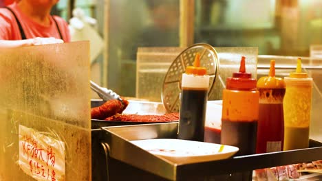 condiments and food at a bustling street stall