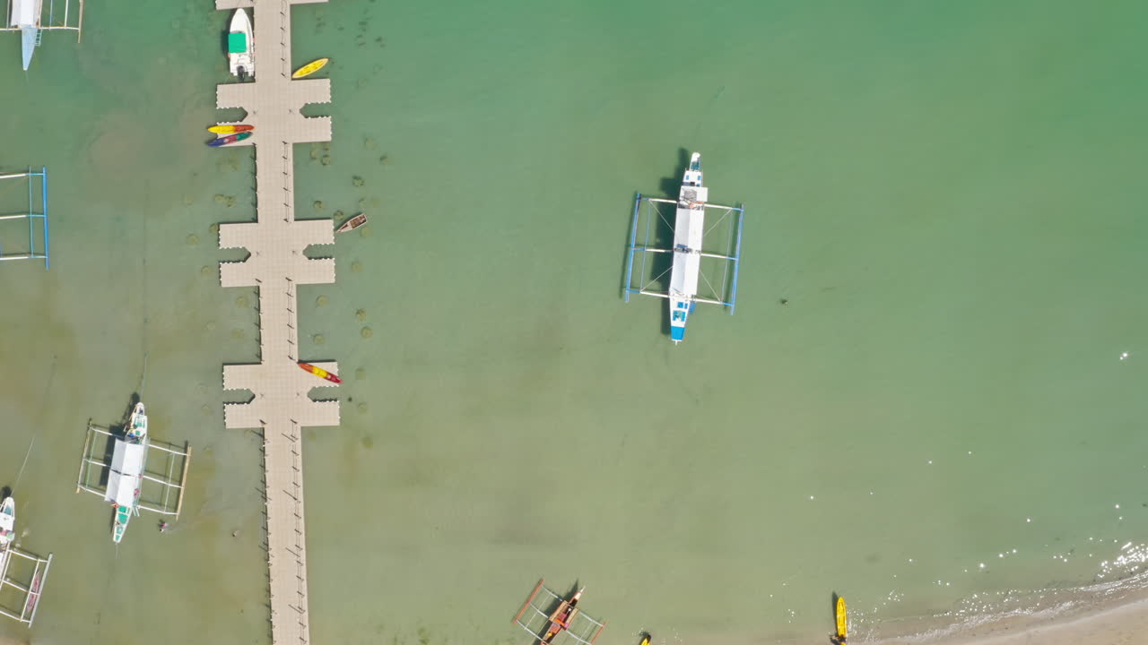 Aerial View of Outrigger Boats and Floating Dock on a Tropical Coastline