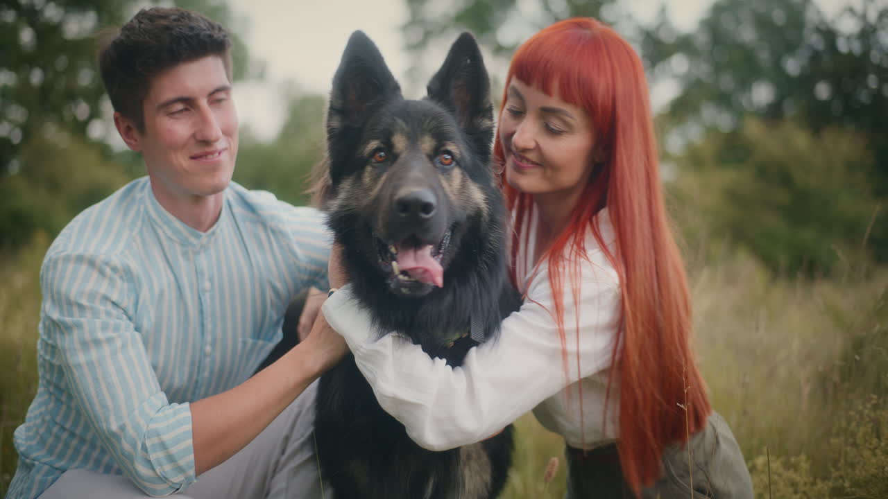 Couple hugging their dog