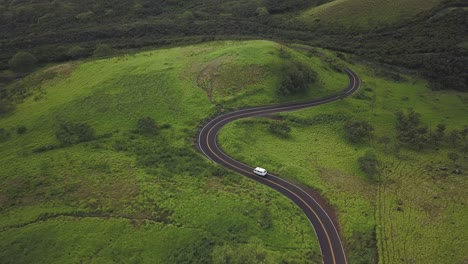 aerial footage of a cmapervan driving along the open coastline