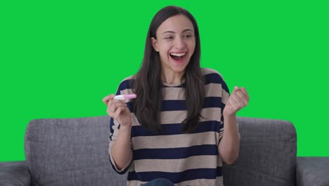 Excited-Indian-girl-checking-pregnancy-test-Green-screen